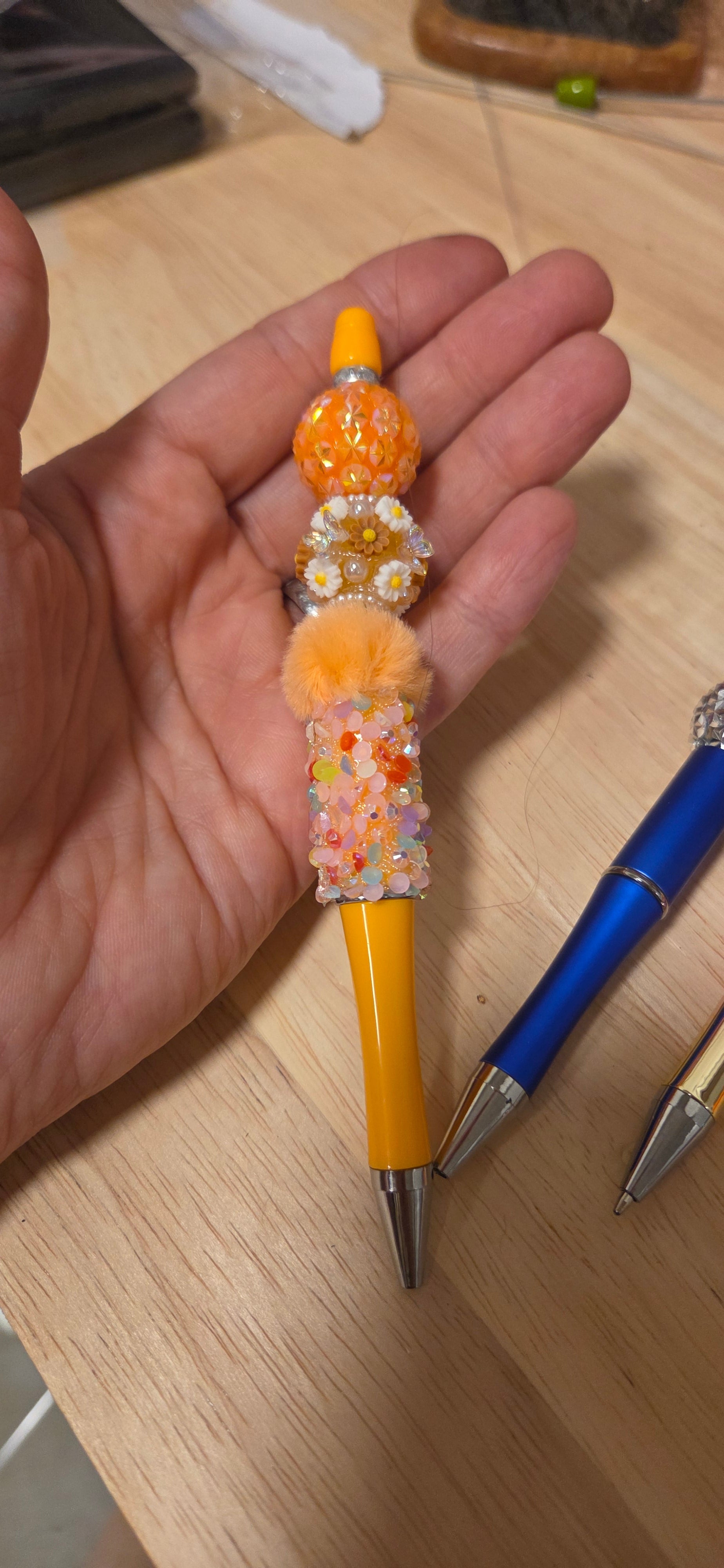 Orange sunshine beaded pen with pom pom and daisy focal bead
